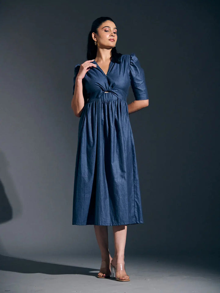 Risate twist detail maxi dress in navy blue featuring a gathered waist and stylish puff sleeves