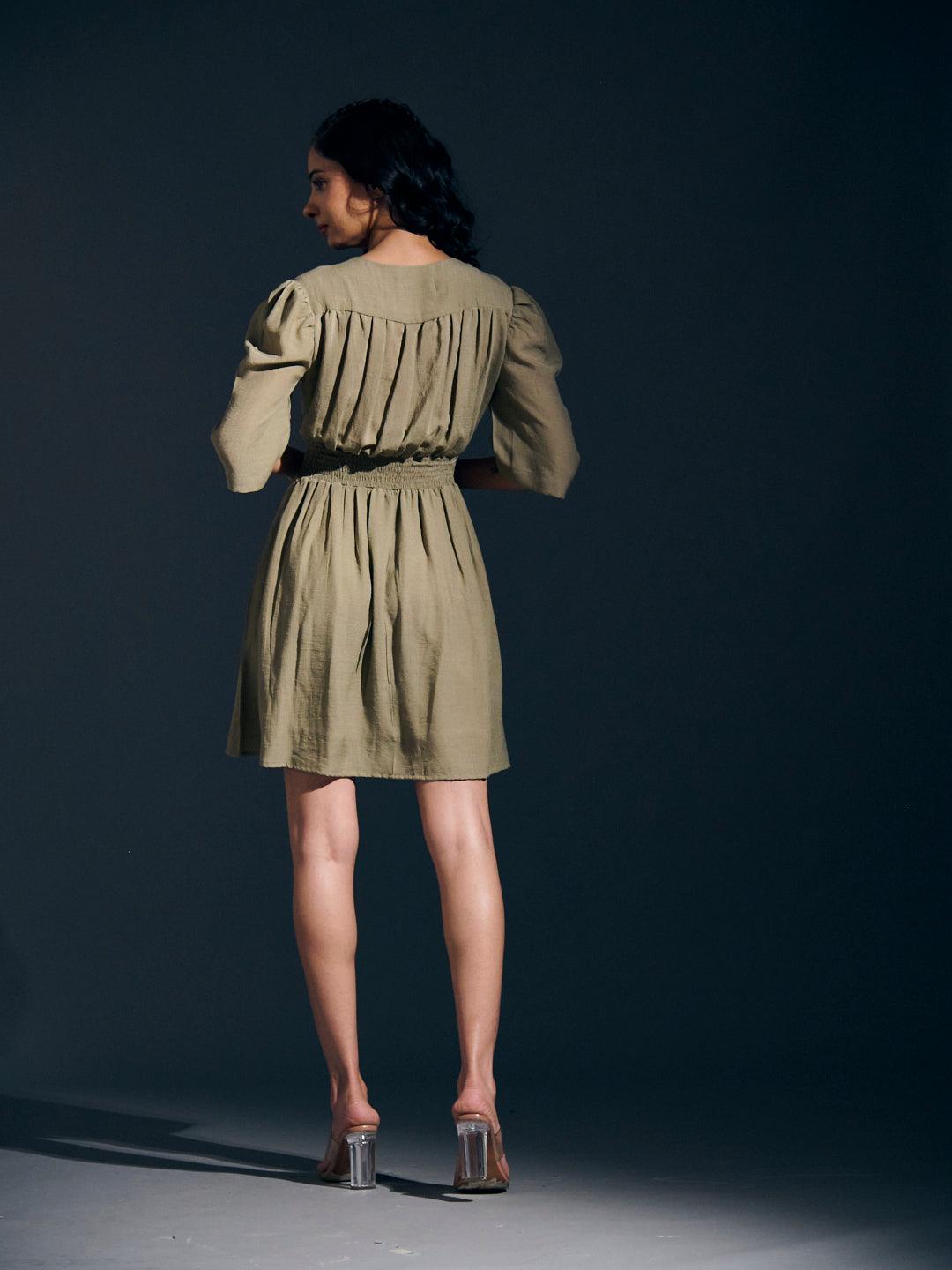 Risate twist detail mini linen dress in olive green with puff sleeves and a gathered back design