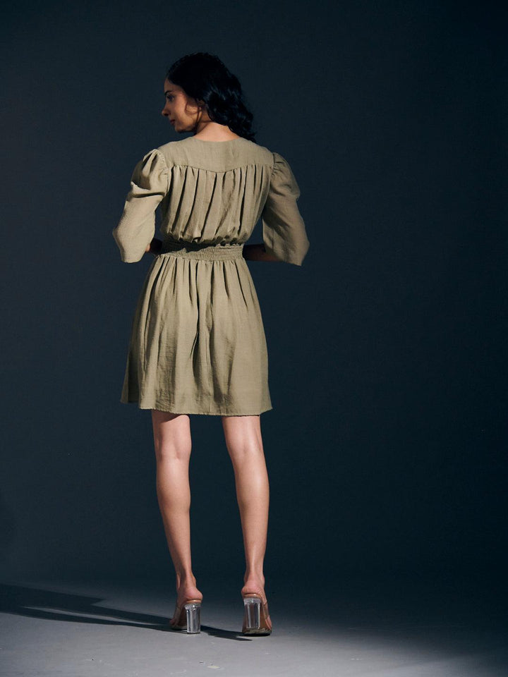 Risate twist detail mini linen dress in olive green with puff sleeves and a gathered back design