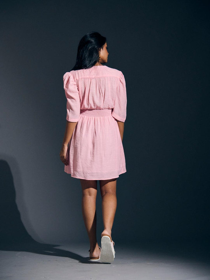 Risate twist detail mini linen dress in pink with puff sleeves and a flattering fit