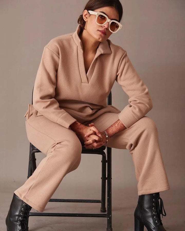 Risate beige co-ord set featuring an ugly Christmas pullover styled with chic sunglasses