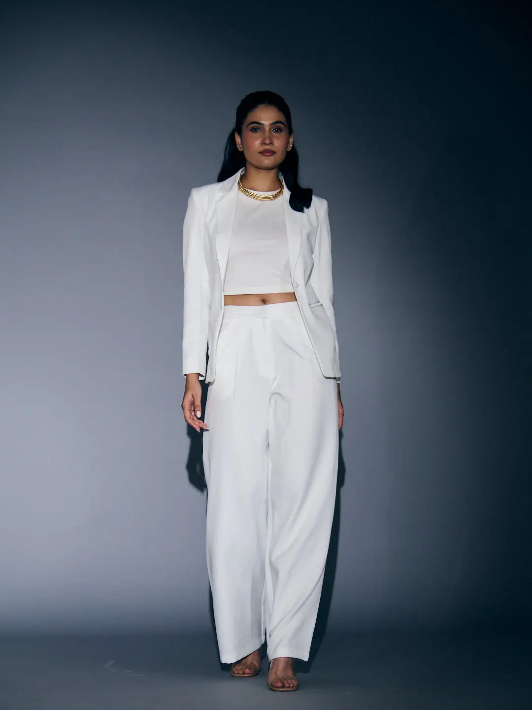 Elegant white blazer and pants set for women featuring a fitted crop top and wide-leg pants