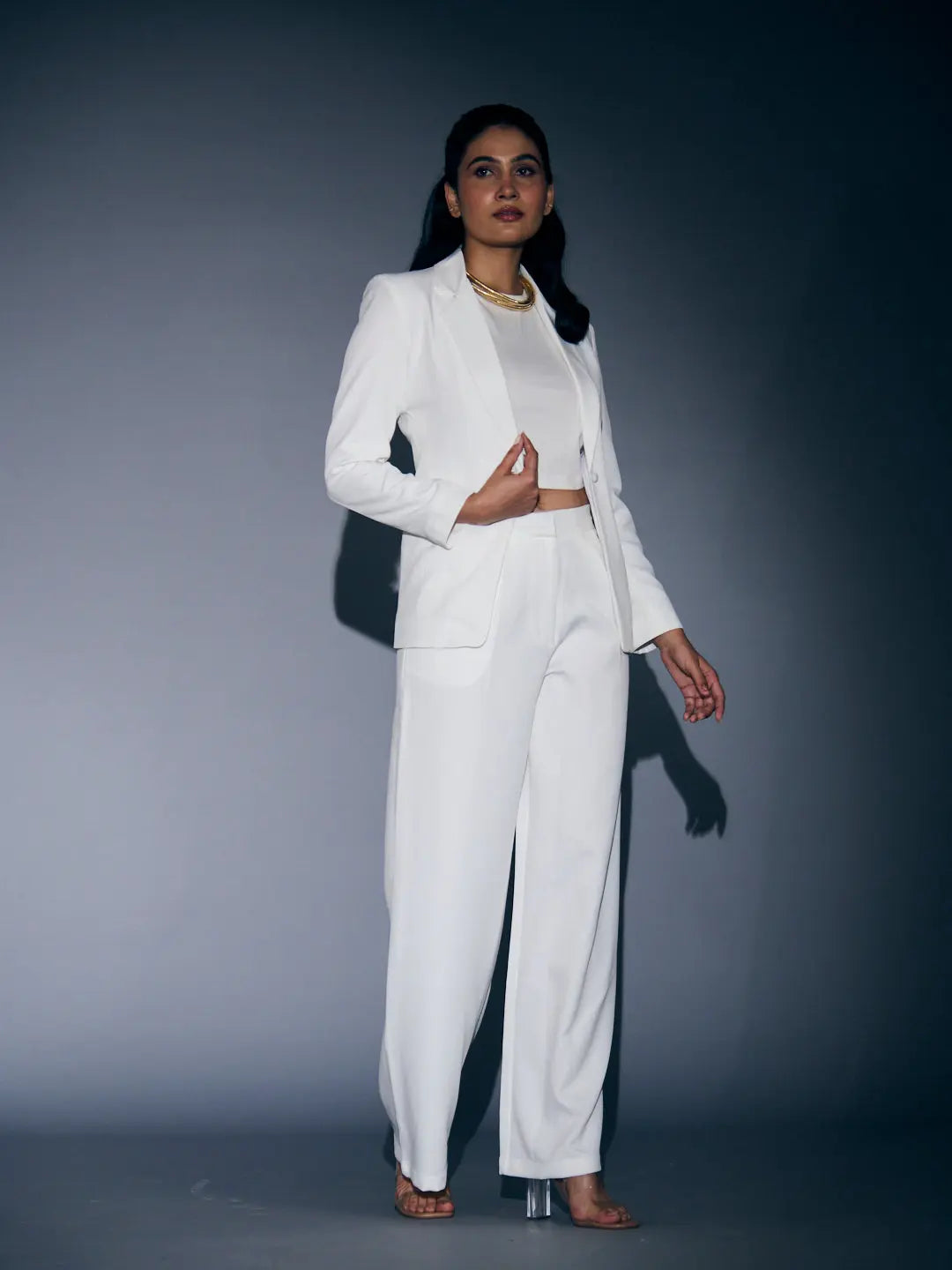Stylish white blazer and pants set for women featuring a cropped design and elegant silhouette