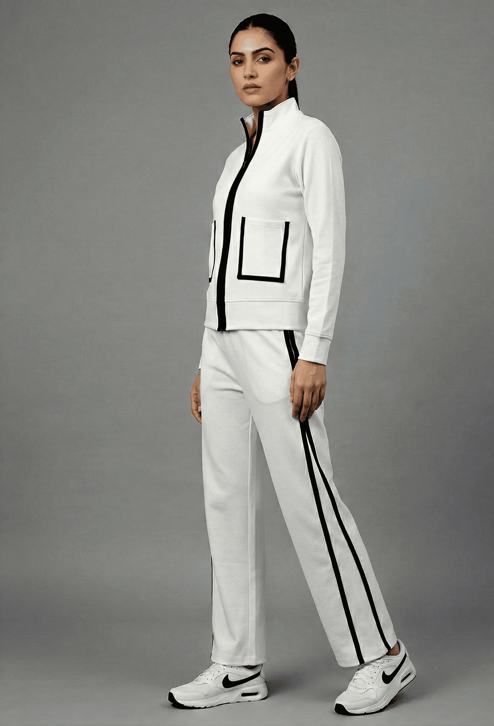 Risate white luxe track set for women featuring a zip-up jacket and matching pants with black accents