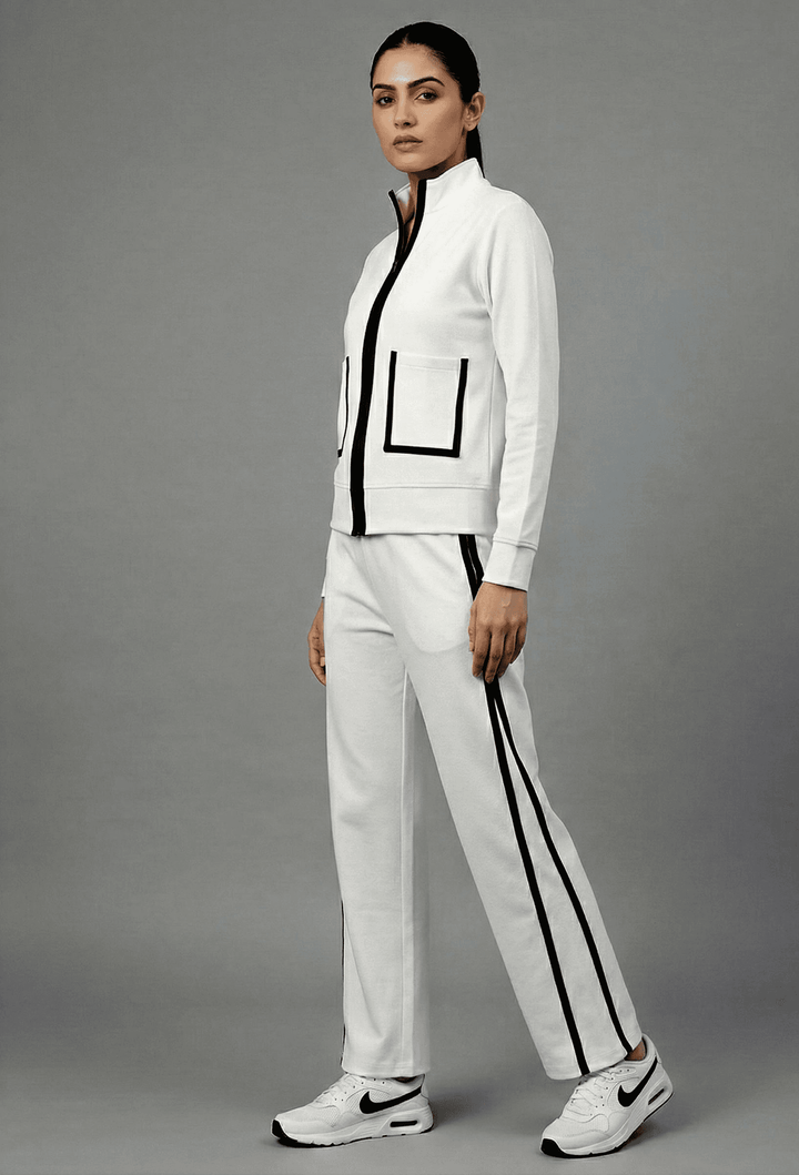 Risate white luxe track set for women featuring a zip-up jacket and matching pants with black accents