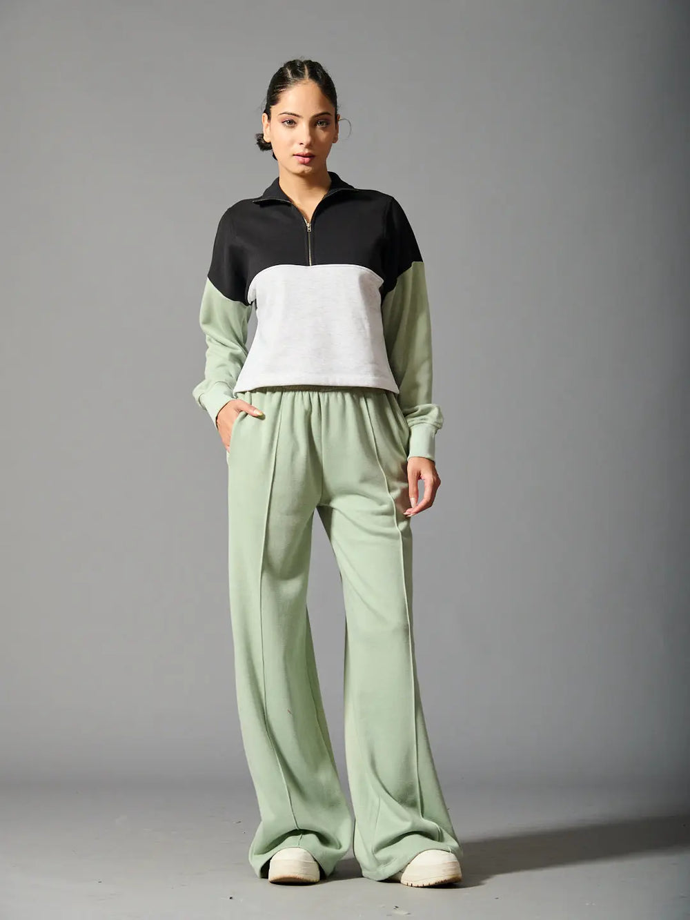 Willows coord set for women featuring a black and white zip-up top with green wide-leg pants