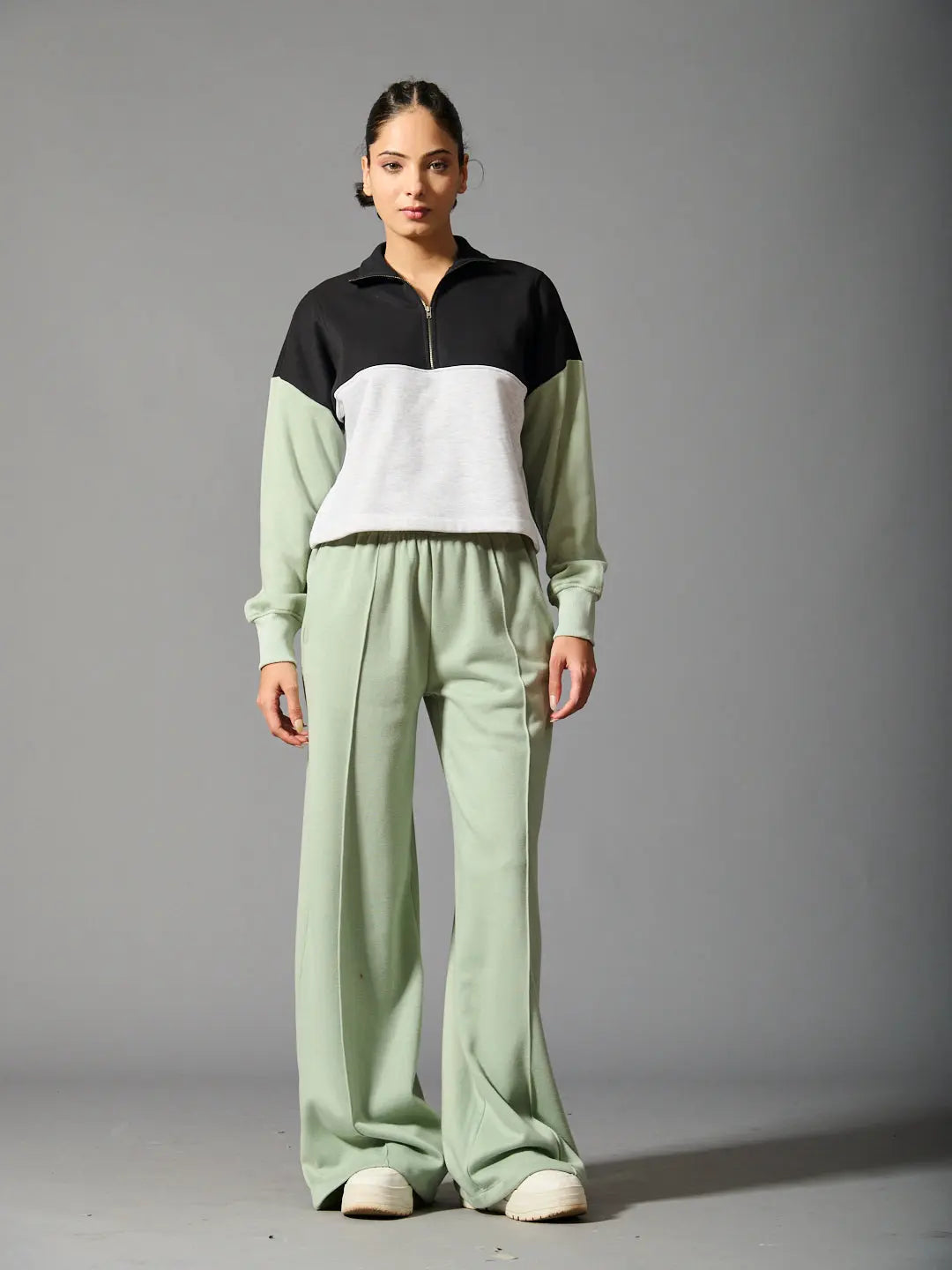 Risate Willows coord set for women featuring a black and gray zip-up top and green wide-leg pants