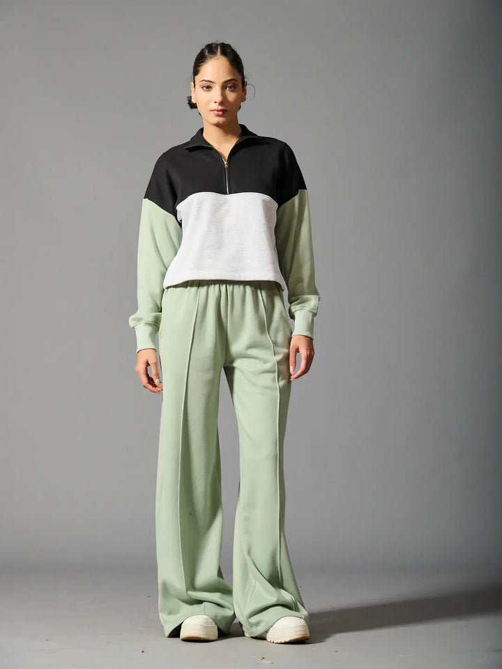 Risate Willows coord set for women featuring a black and gray zip-up top and green wide-leg pants