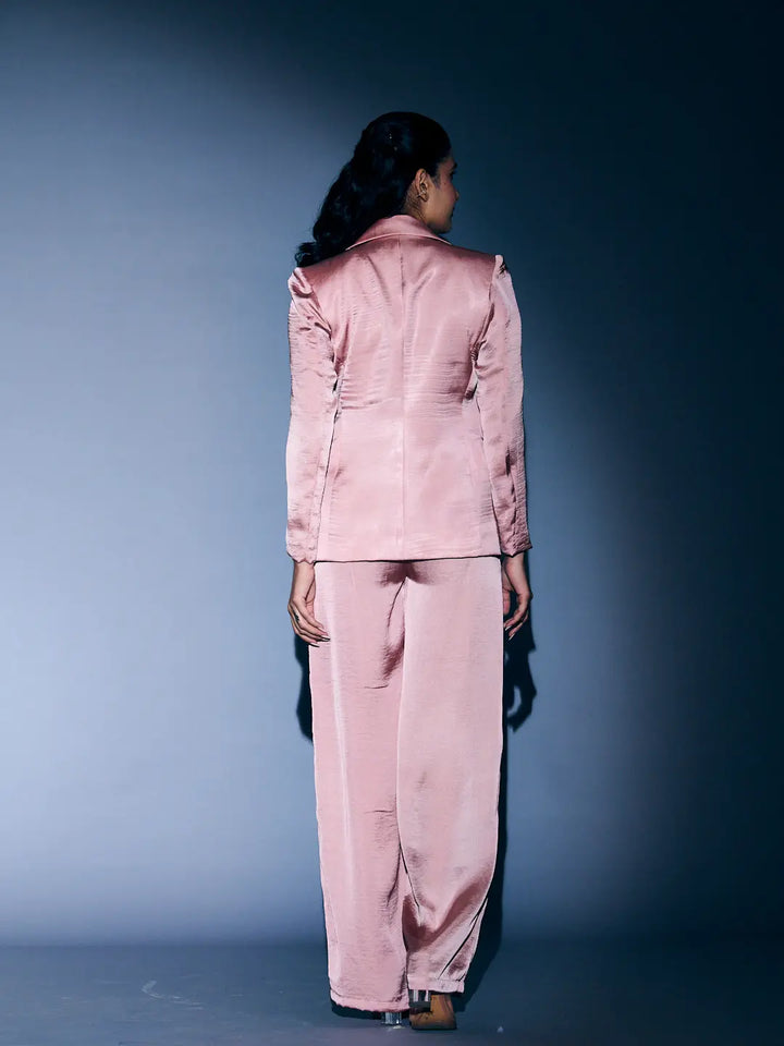 Back view of women's 3 piece coord set in soft pink with a stylish blazer and wide-leg pants