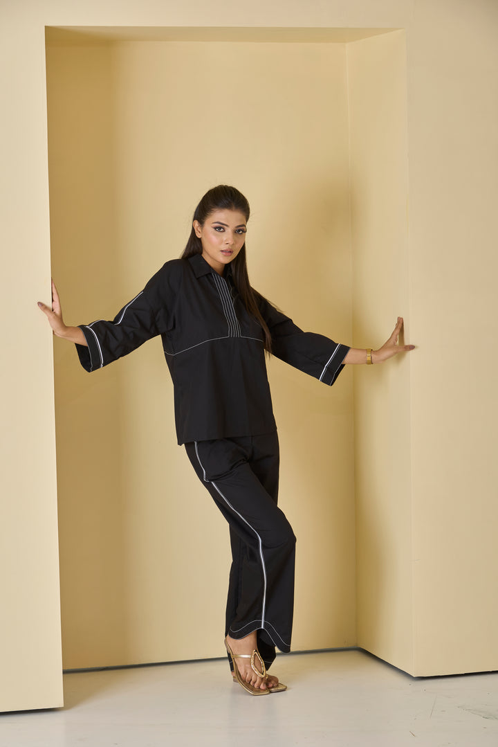 Women's black piped western set featuring a stylish top and pants with contrasting piping details