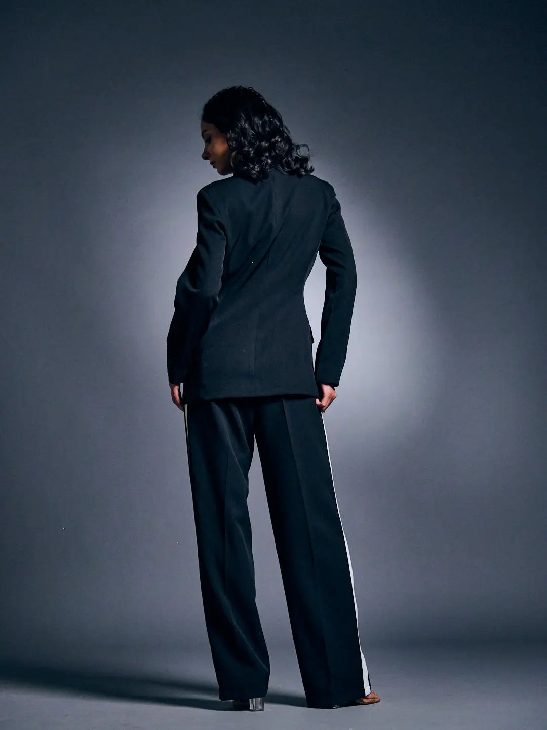 Stylish Risate women's blazer suit set showcased from the back, featuring tailored pants and a fitted blazer