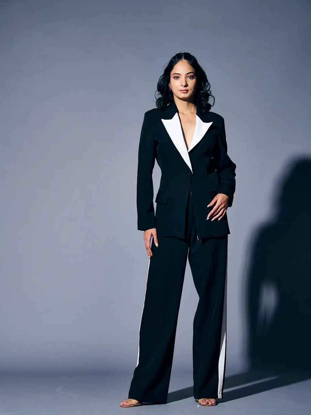 Risate women's blazer suit set in black with contrasting white lapels, featuring tailored pants for a chic look