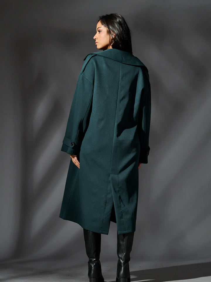 Back view of women's classic trench coat by Risate in deep green, featuring a relaxed fit and stylish design