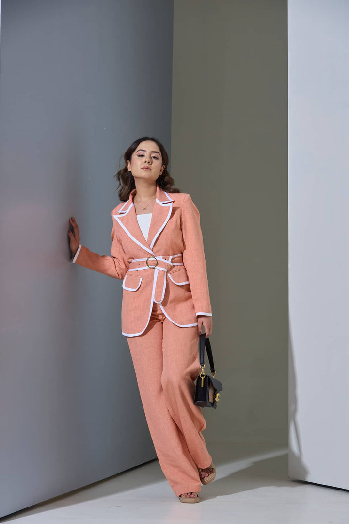 Stylish women's co-ord set for office in coral with white trim, featuring a belted blazer and wide-leg pants