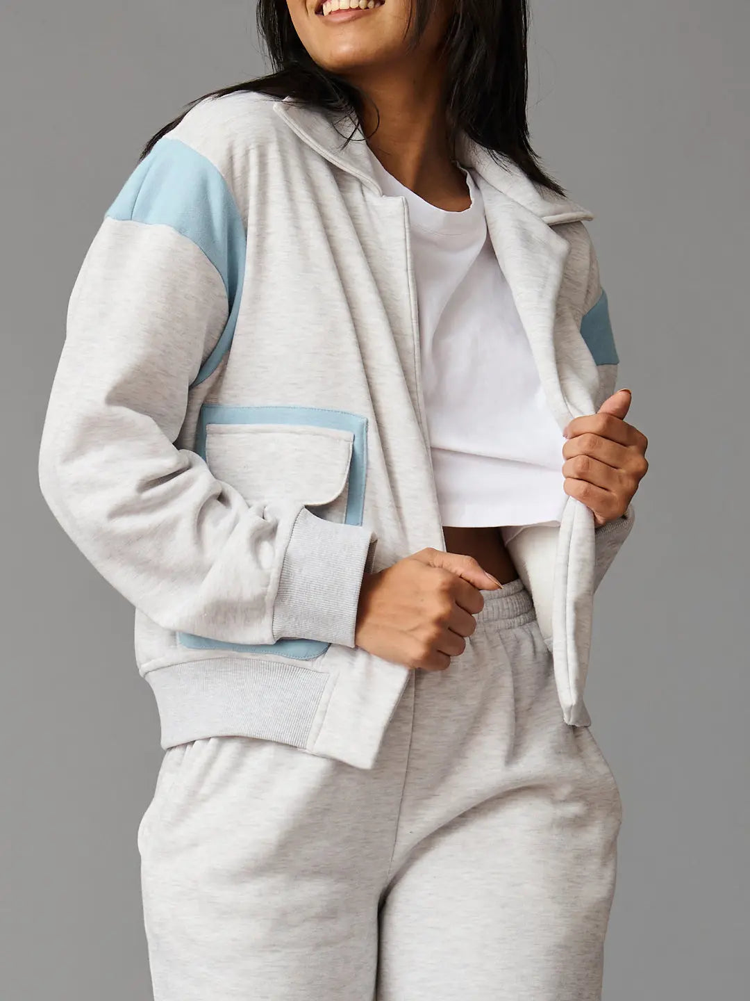 Risate women's co-ord set featuring a gray zip-up jacket with blue accents and matching sweatpants