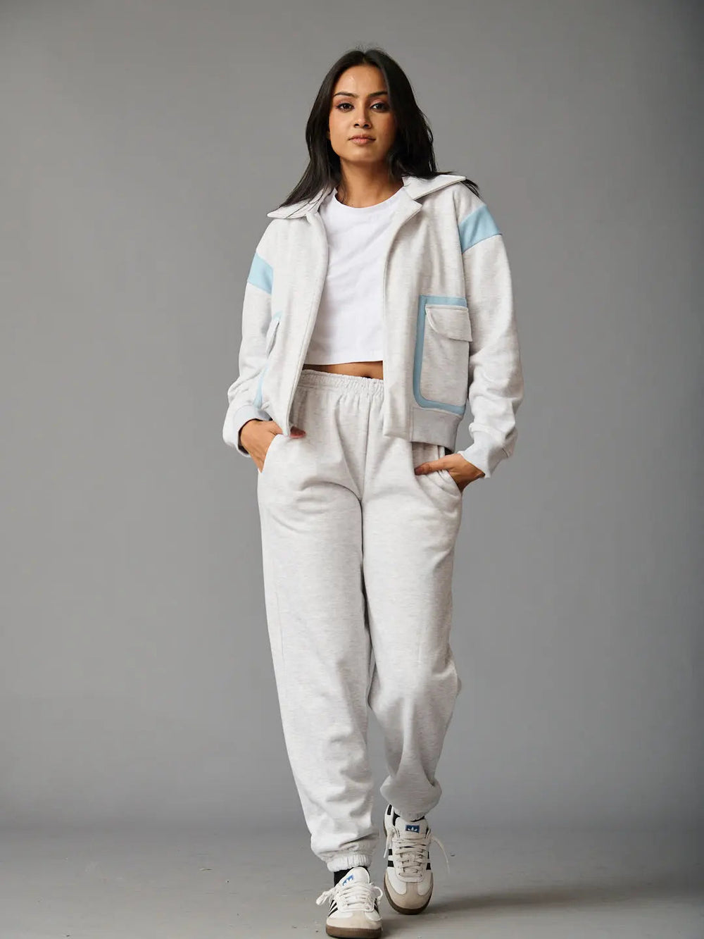 Stylish women's co-ord set by Risate featuring a zip-up jacket and matching joggers in light gray