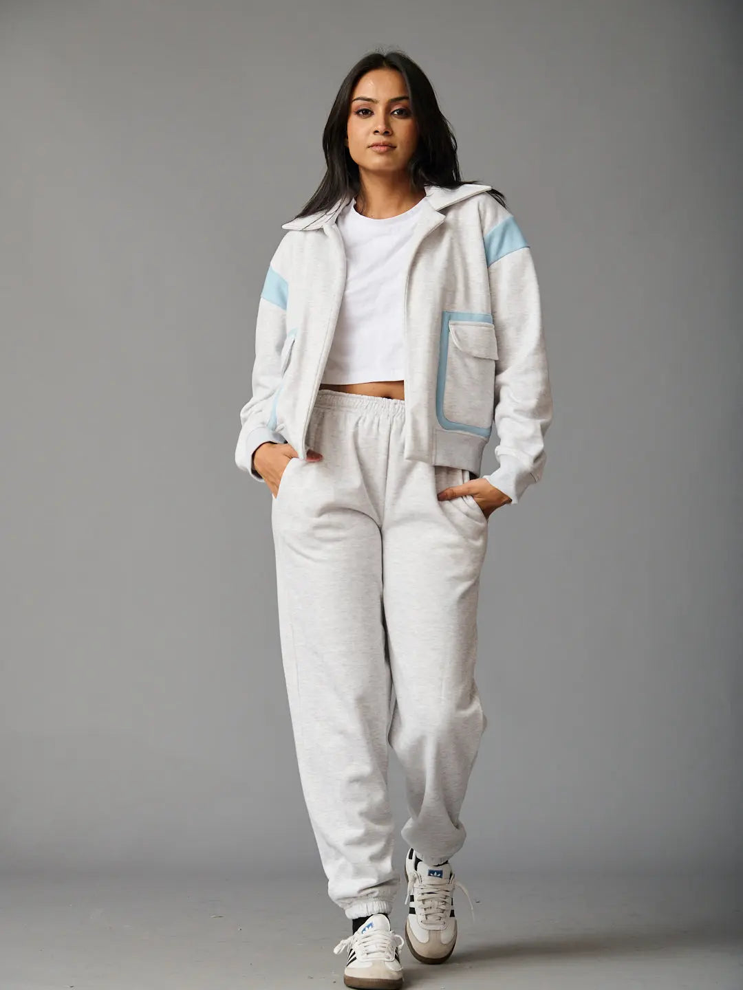 Stylish women's co-ord set by Risate featuring a zip-up jacket and matching joggers in light gray