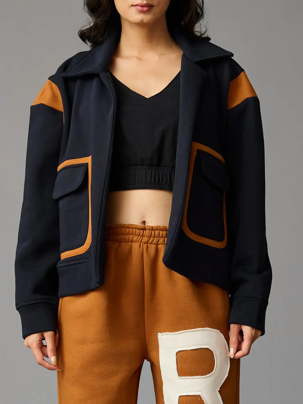 Risate women's co-ord set featuring a cropped black top and stylish navy jacket with pockets