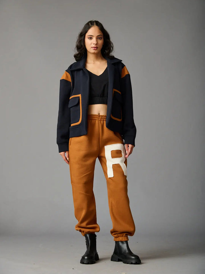 Risate women's co-ord set featuring a cropped black top and brown jogging pants with pockets