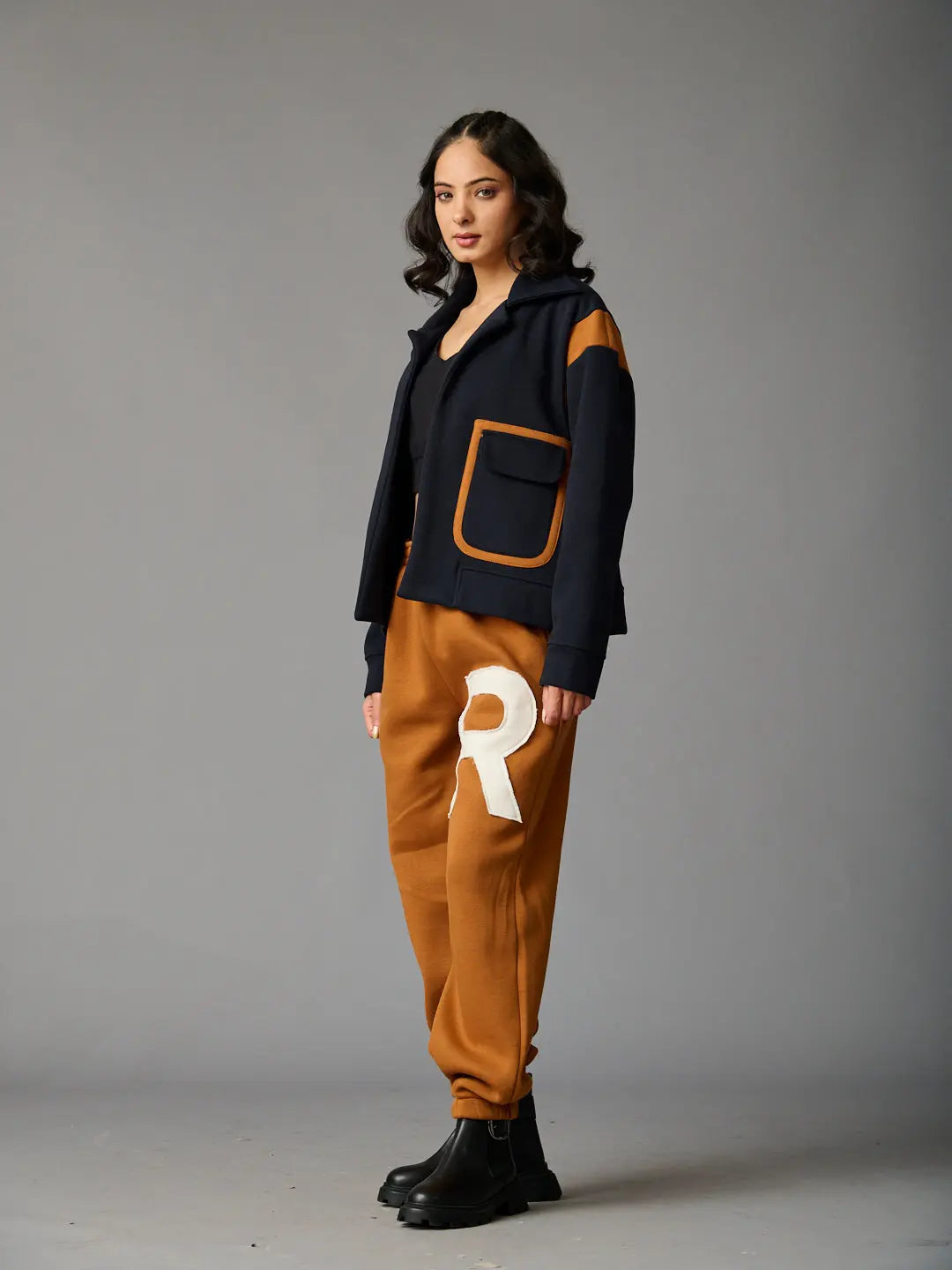 Risate women's co-ord set featuring a navy jacket with pockets and brown joggers with a logo
