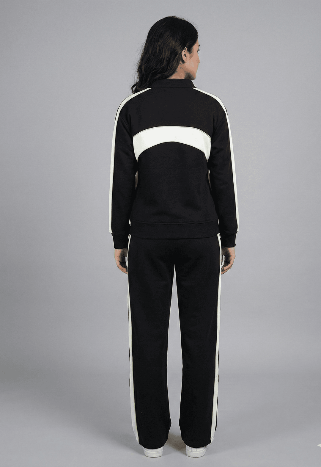 Back view of a women's color-block tracksuit from Risate with contrasting white stripes