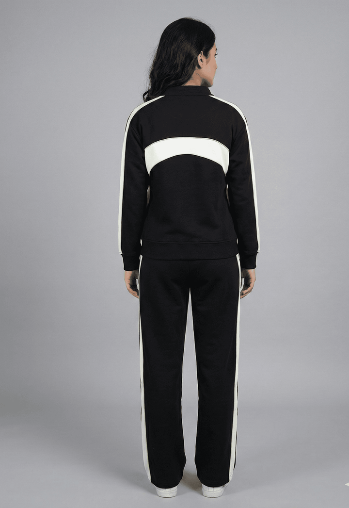 Back view of a women's color-block tracksuit from Risate with contrasting white stripes