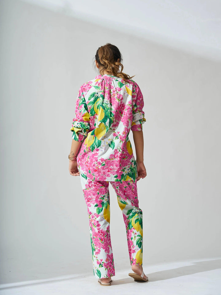 Back view of a colorful women's cotton co-ord set featuring vibrant floral patterns