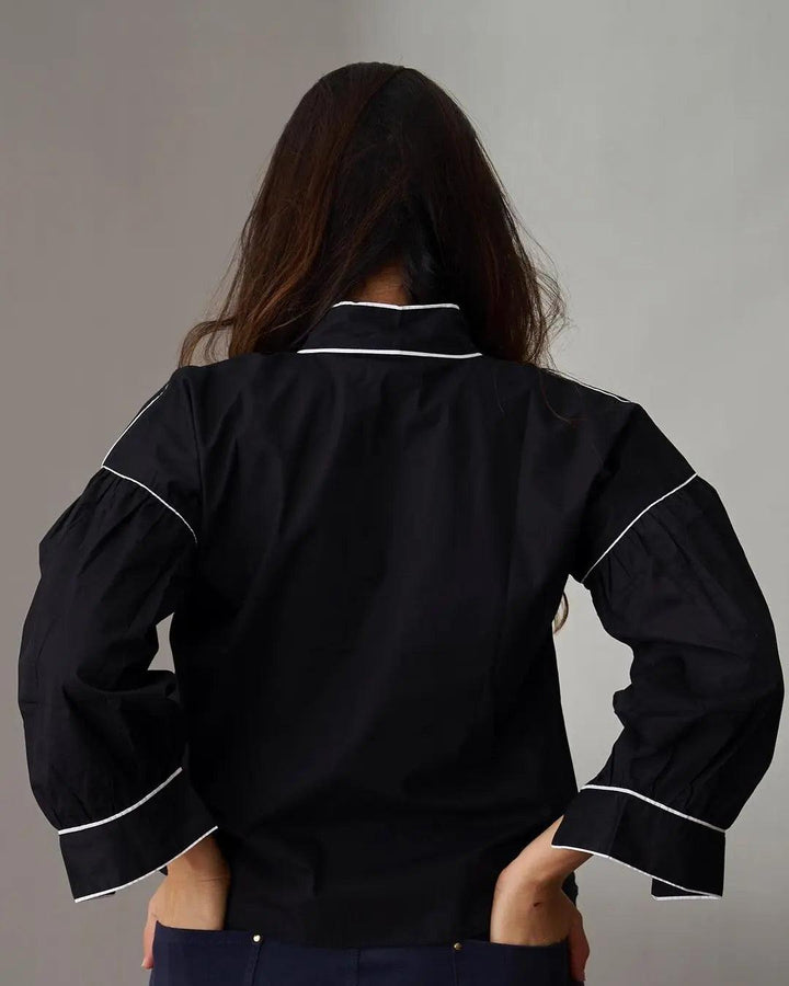 Back view of Risate women's cotton poplin shirt in black with contrasting white piping details