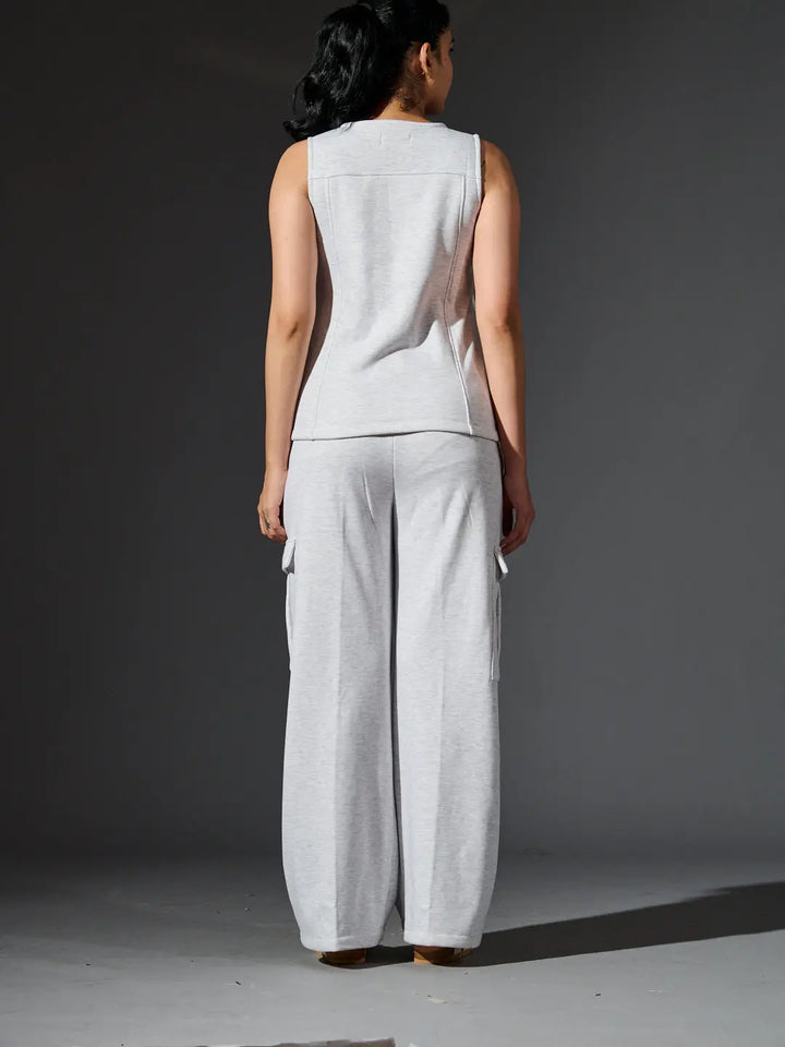 Back view of women's fleece coords set by Risate in light gray with a sleeveless top and wide-leg pants