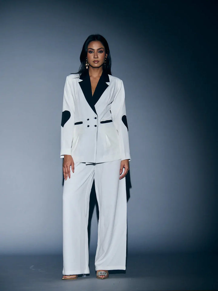 Stylish women's heart patch pant suit in white and black by Risate, perfect for chic occasions
