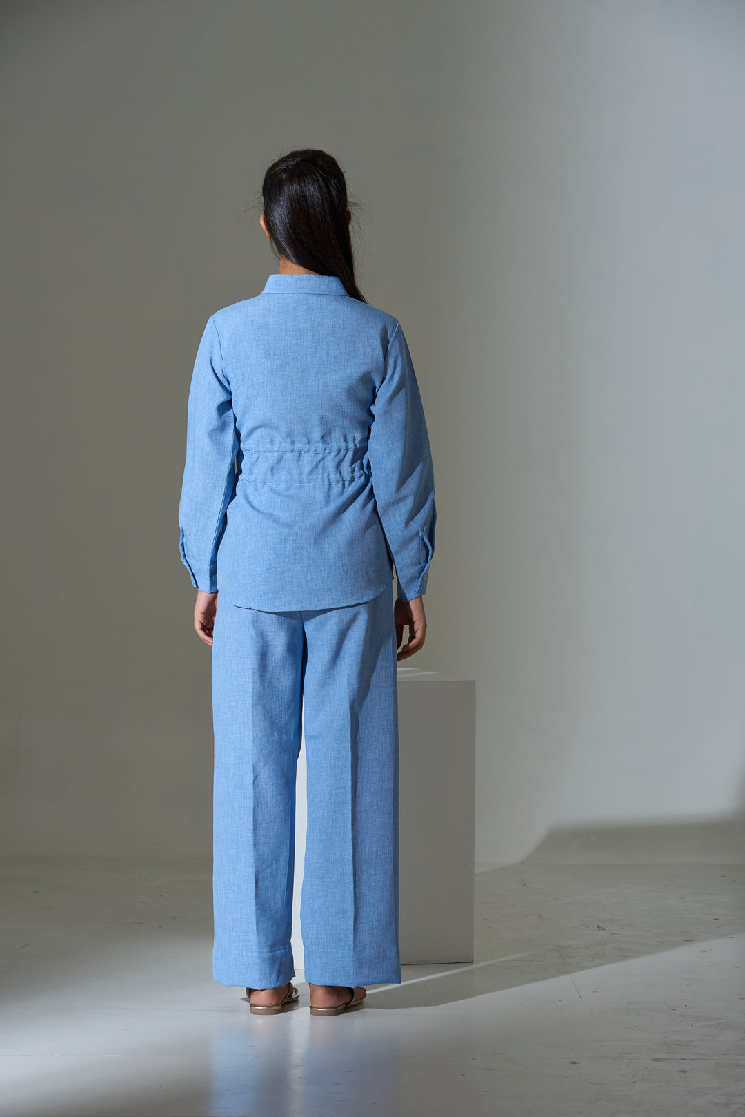 Back view of women's western cinch shirt by Risate in light blue with a relaxed fit