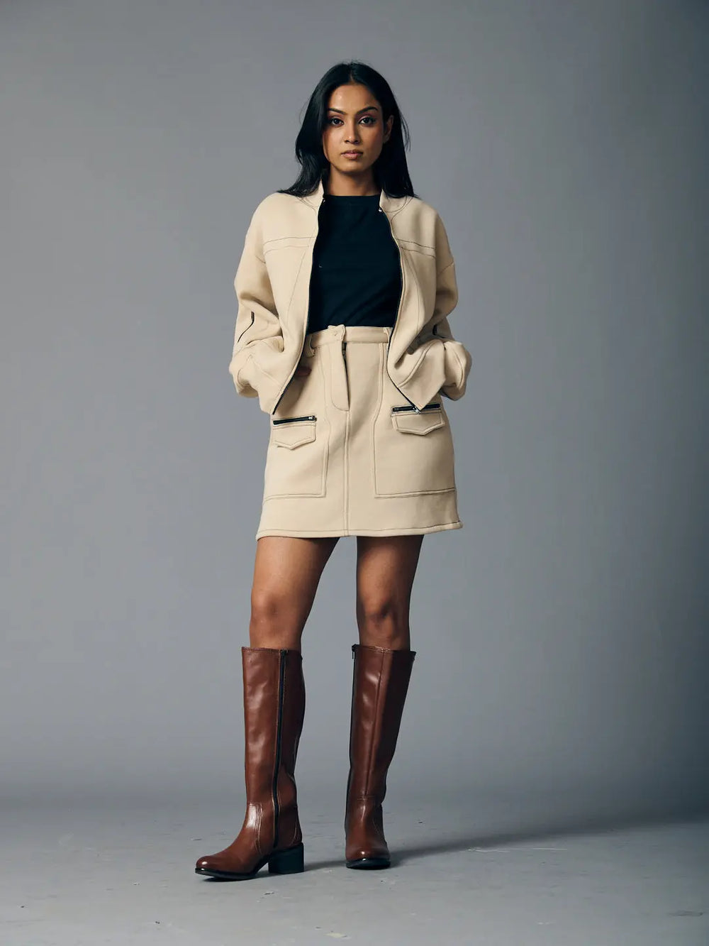 Stylish women's western fleece set in beige featuring a zip-up jacket and matching skirt