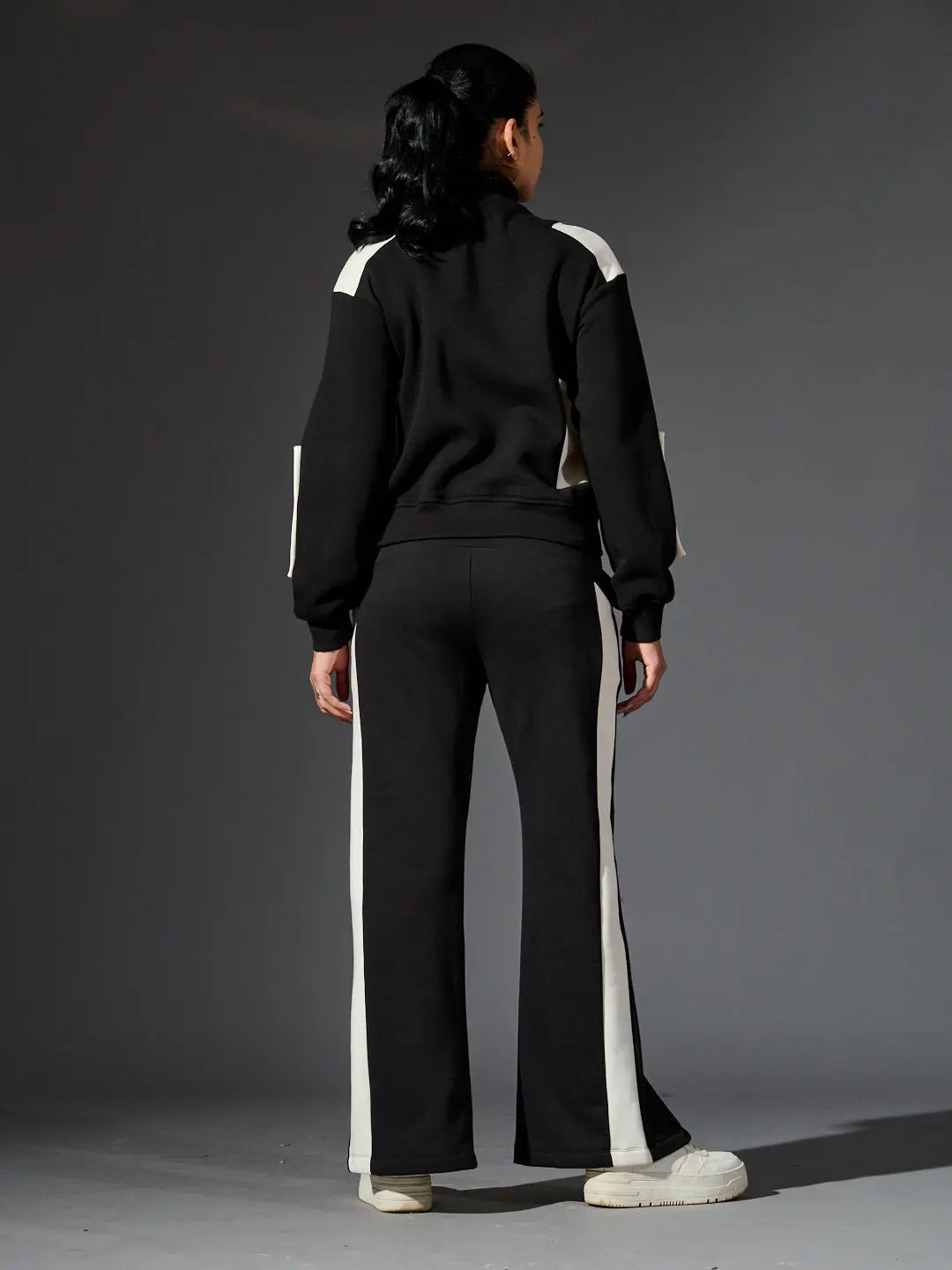 Stylish women's western luxe jacket from Risate paired with trendy black track pants
