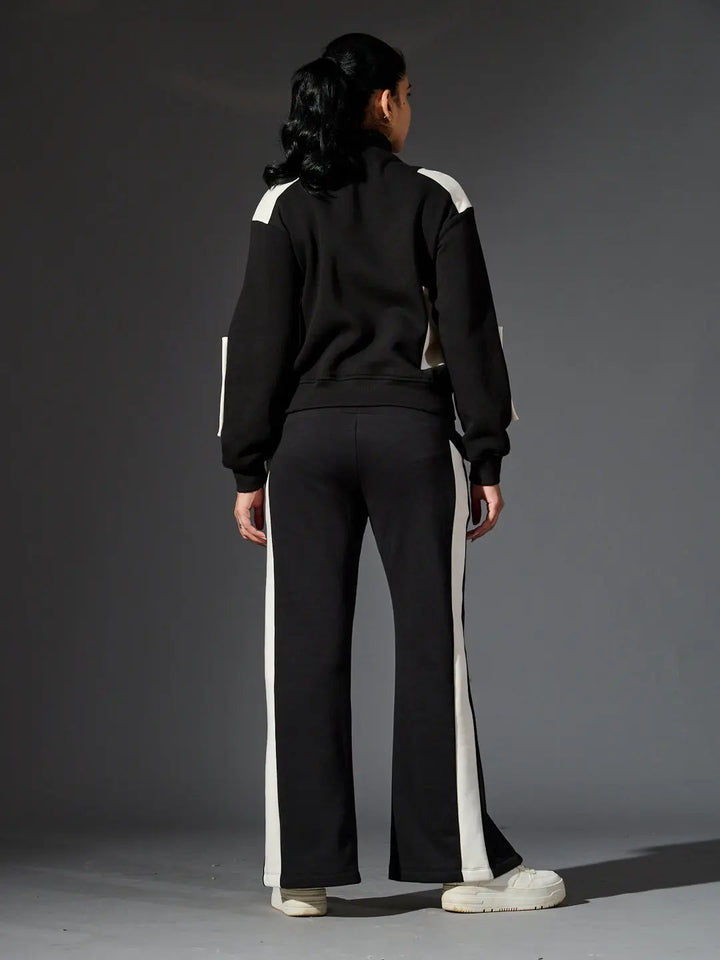 Stylish women's western luxe jacket from Risate paired with trendy black track pants