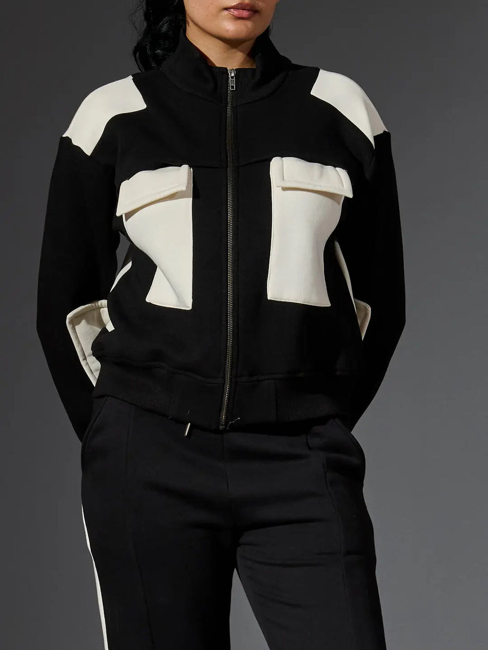 Risate women's western luxe jacket in black and white with unique front pockets and a stylish zip-up design