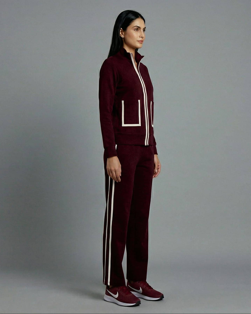 Risate women's wine track set featuring a zip-up jacket and matching pants with side stripes