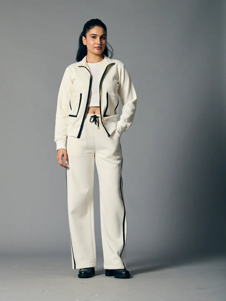 Risate women's zipper coord set in cream with contrasting black trim and relaxed fit pants